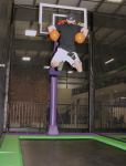 Man Slam Dunking Two Balls on Trampoline Basketball Court